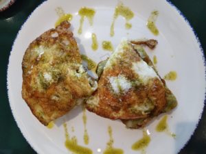 photo of well-done eggs cooked in coconut oil with avocado and almonds on gluten-free toast