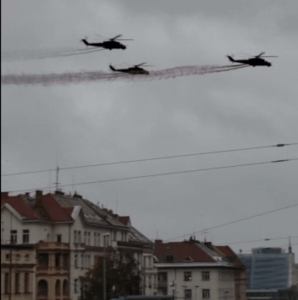 3 helicopters trailing red, white, blue smoke